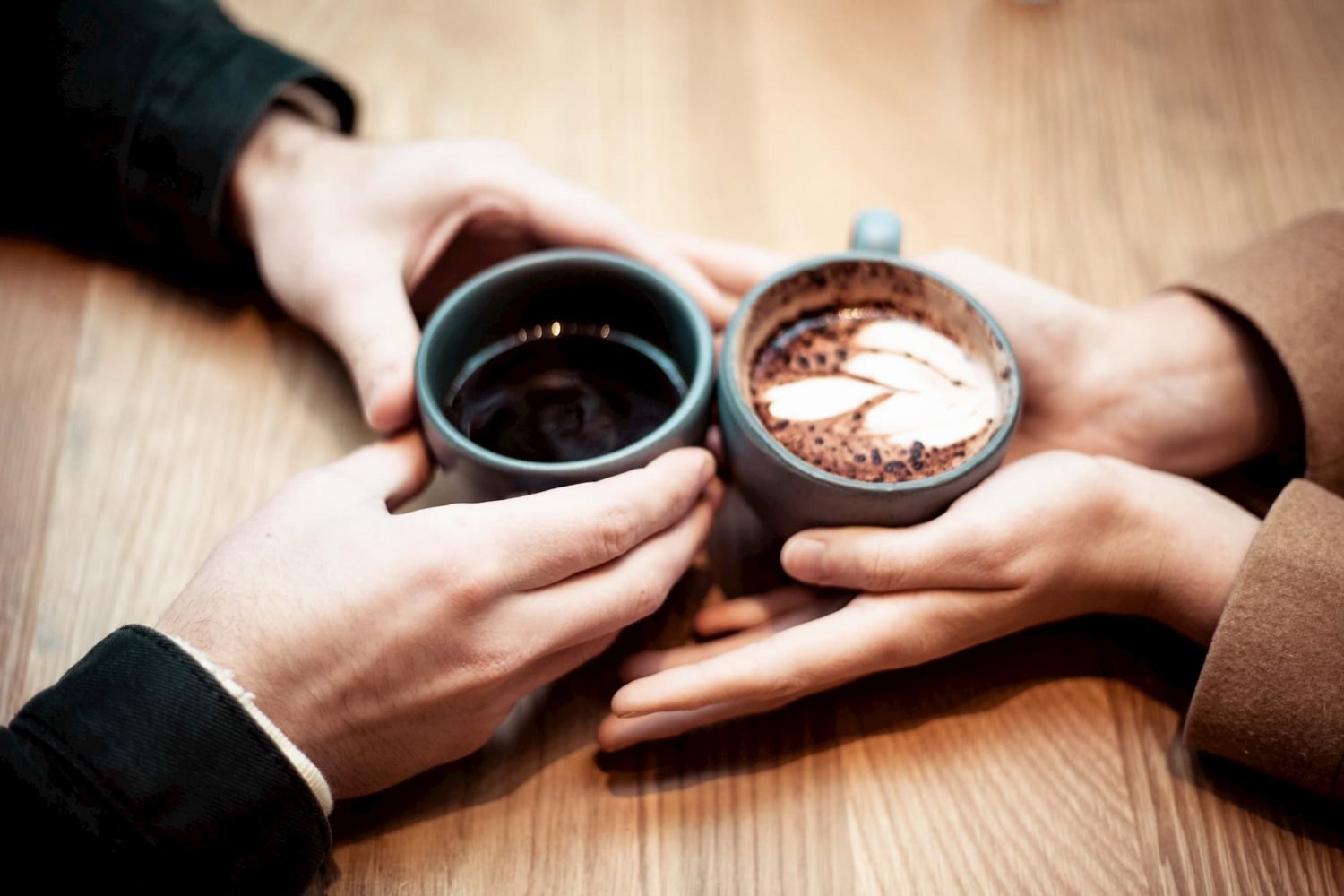 Two people with coffee cups