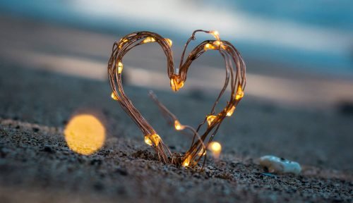 heart shaped with lights on the shore